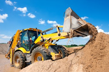 depositphotos 26524151 stock photo excavator machine unloading sand with